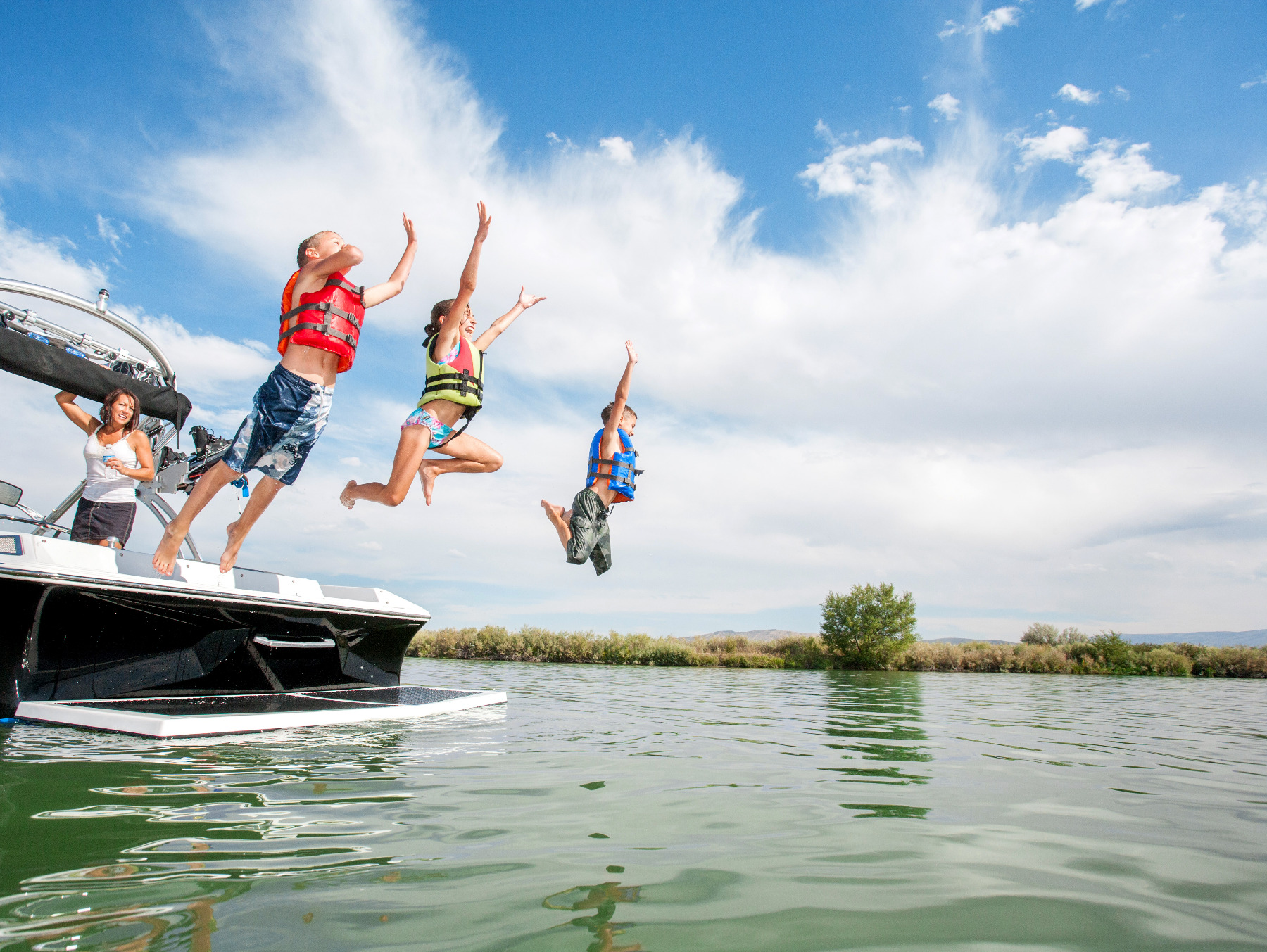Kids jumping from boat